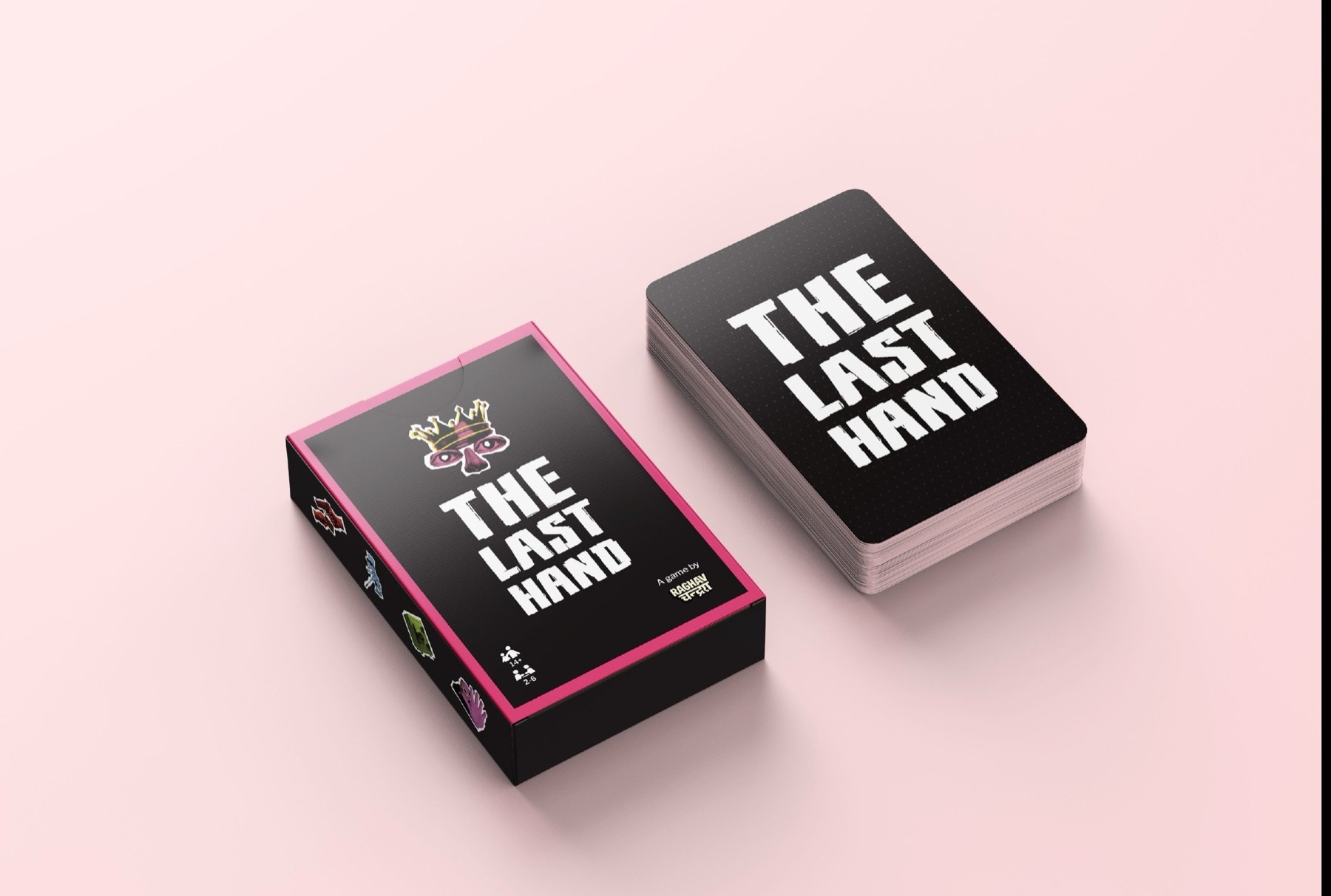 The Last Hand card game box and deck on a pink background - black tuck box with pink foil edge, crown-and-eyes logo mark